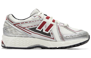 Medial side profile of white, silver, and red New Balance shoes 1906R model, featuring a breathable white mesh base with metallic silver overlays, burgundy-red N-lock lace webbing, a silver molded TPU heel counter, and an off-white N-ergy cushioned midsole.