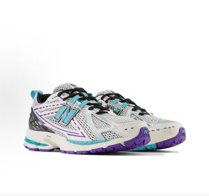 New Balance shoes 1906R model, three-quarter pair product shot highlighting white and silver mesh uppers, teal N-lock lace webbing, purple structural line details, black heel counters, and N-ergy shock-absorbing soles.