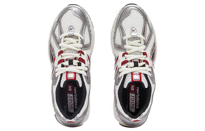 Top-down overhead view of a pair of white, silver, and red New Balance shoes 1906R sneakers.