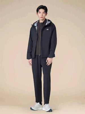 Full-length view of a male model wearing full sportswear paired with a comfortable حذاء نيو بالانس suitable for running or daily walks.