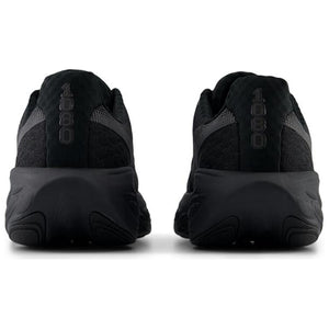 Direct rear view of a pair of all-black New Balance Fresh Foam X 1080 running shoes, displaying the vertical "1080" text on the heel pull tabs and the thick black midsoles