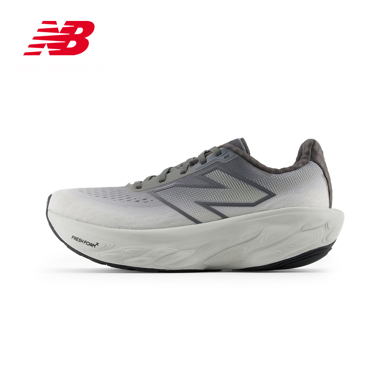 Lateral side profile of a grey New Balance running shoe featuring a gradient mesh upper fading from light to dark grey, dark outline "N" logo, thick light grey Fresh Foam X sole, and red branding logo in the upper left corner.
