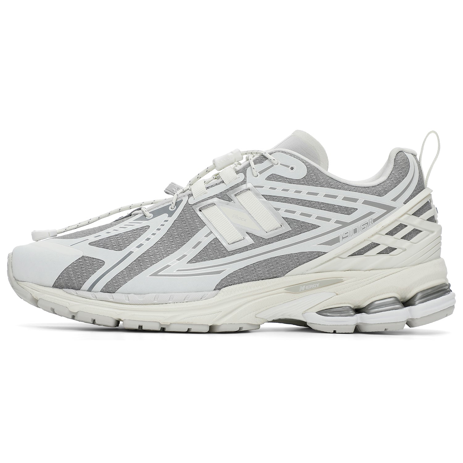 Lateral side profile of grey and white New Balance shoes 1906R model, featuring a textured grey mesh base with white and silver overlays, white toggle speed lacing system, off-white heel TPU cage with pull tab, and a white N-ergy cushioned midsole.