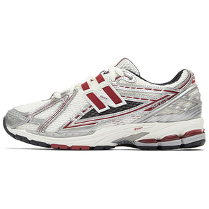 Lateral side profile of white, silver, and red New Balance shoes 1906R model, featuring a breathable white mesh base with metallic silver overlays, burgundy-red N-lock lace webbing, a silver TPU heel counter, and an off-white N-ergy cushioned sole with dark red heel pods.