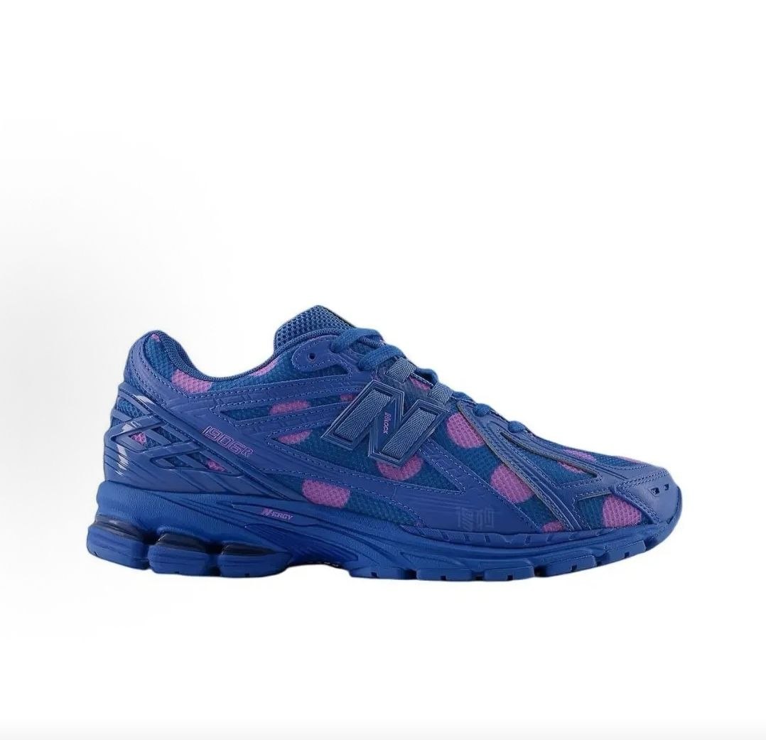 Medial side profile view of blue and purple polka dot New Balance shoes 1906R.