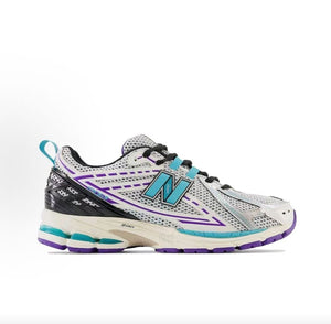 Medial side profile view of white, teal, and purple New Balance shoes 1906R.