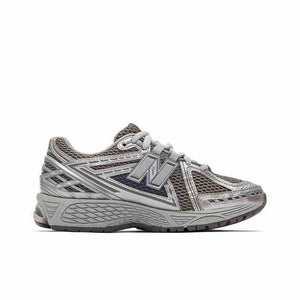 Medial side view profile of dark grey and metallic silver New Balance running shoes