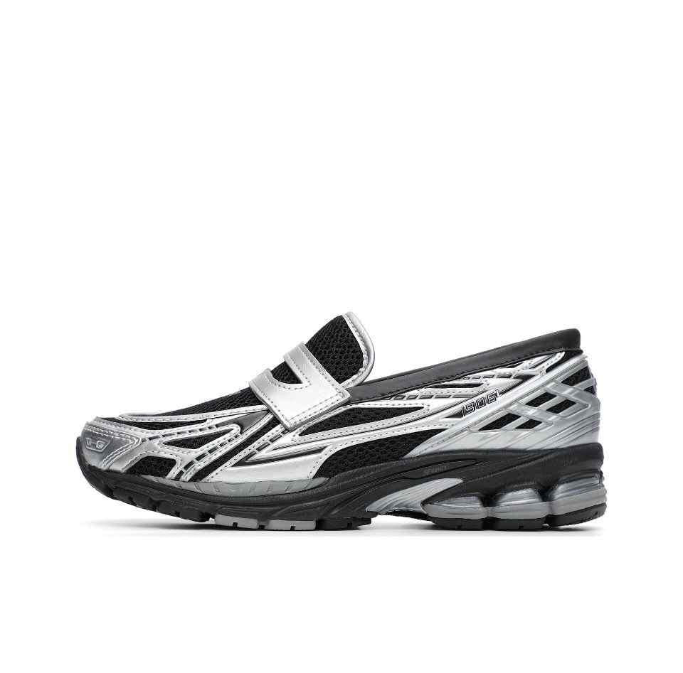 A lateral profile highlighting the New Balance 1906L Black color accented with metallic silver leather.