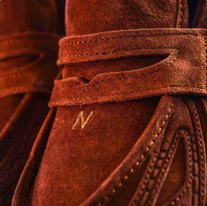 Macro texture view featuring حذاء نيو بالانس focusing on the strap embroidery and material quality.