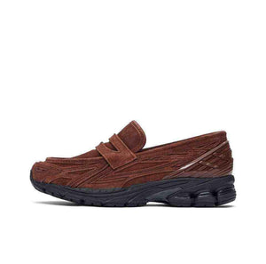A lateral profile showcasing the New Balance 1906L Reddish Brown hybrid loafer with its rich reddish-brown tone and black sole.