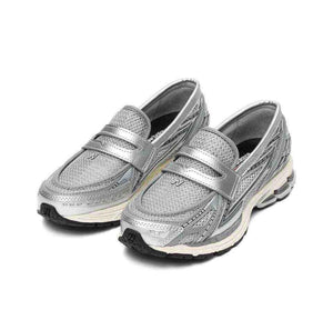 Perspective view of شوز نيو بالانس الأصلي (Original New Balance shoe) displaying the metallic strap and breathable mesh structure.
