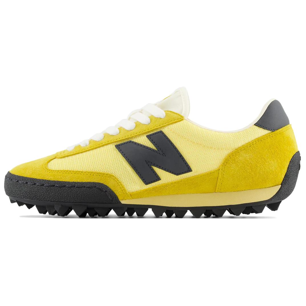 New Balance RC30 low-top sneaker in yellow and black colorway, lateral profile view displaying nylon uppers with suede overlays, black leather N branding, white lacing, and a exaggerated rippled studded rubber outsole.