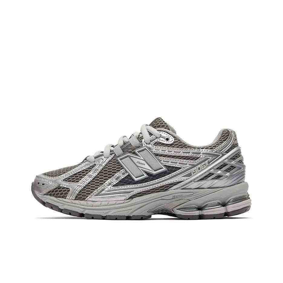 New Balance shoes 1906R in metallic silver and dark grey colorway, lateral profile showing breathable mesh, intricate tech overlays, and N-ergy midsole cushioning