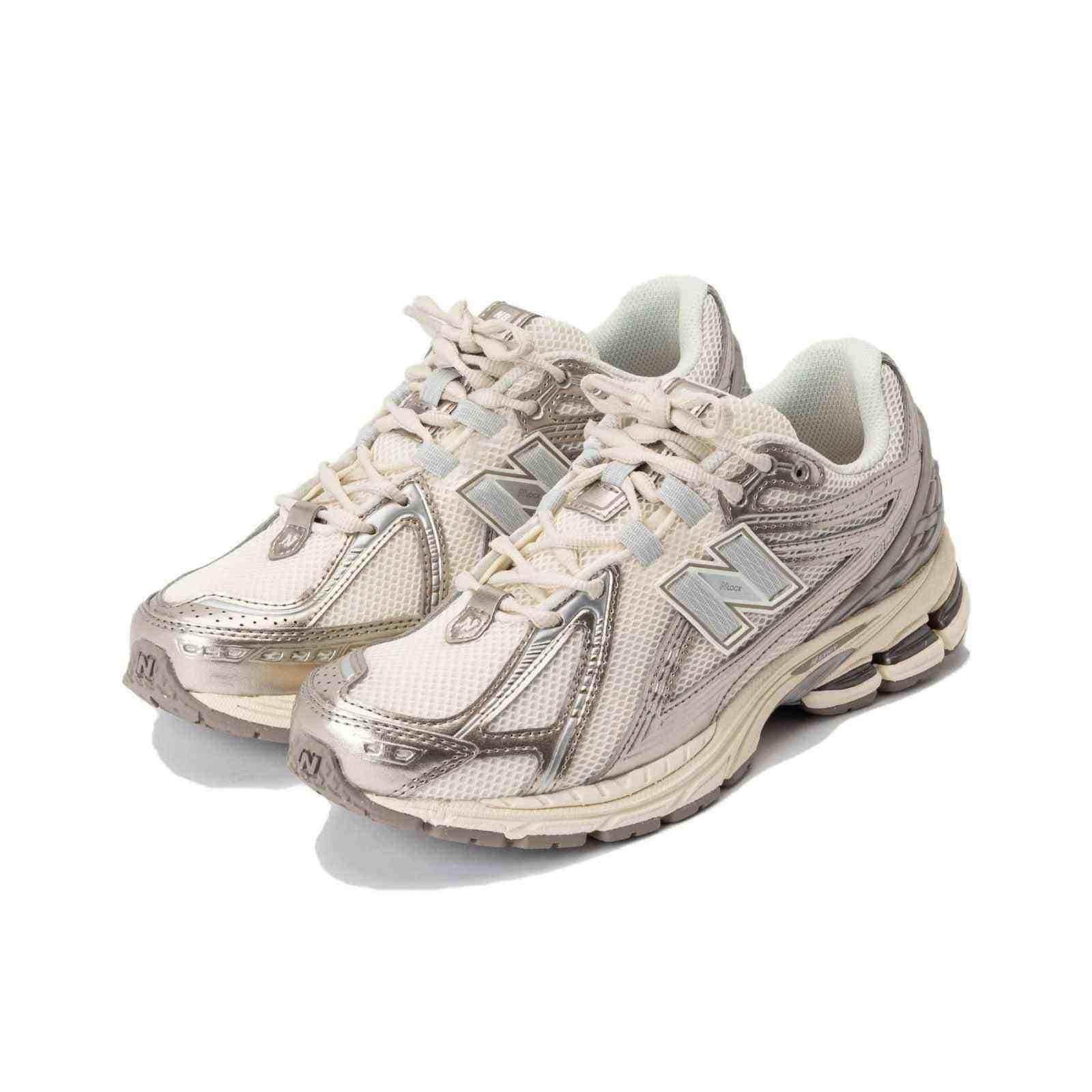 Pair of cream and metallic silver New Balance shoes shown at a three-quarter angle, featuring breathable mesh uppers, silver cage overlays, and cream midsoles.
