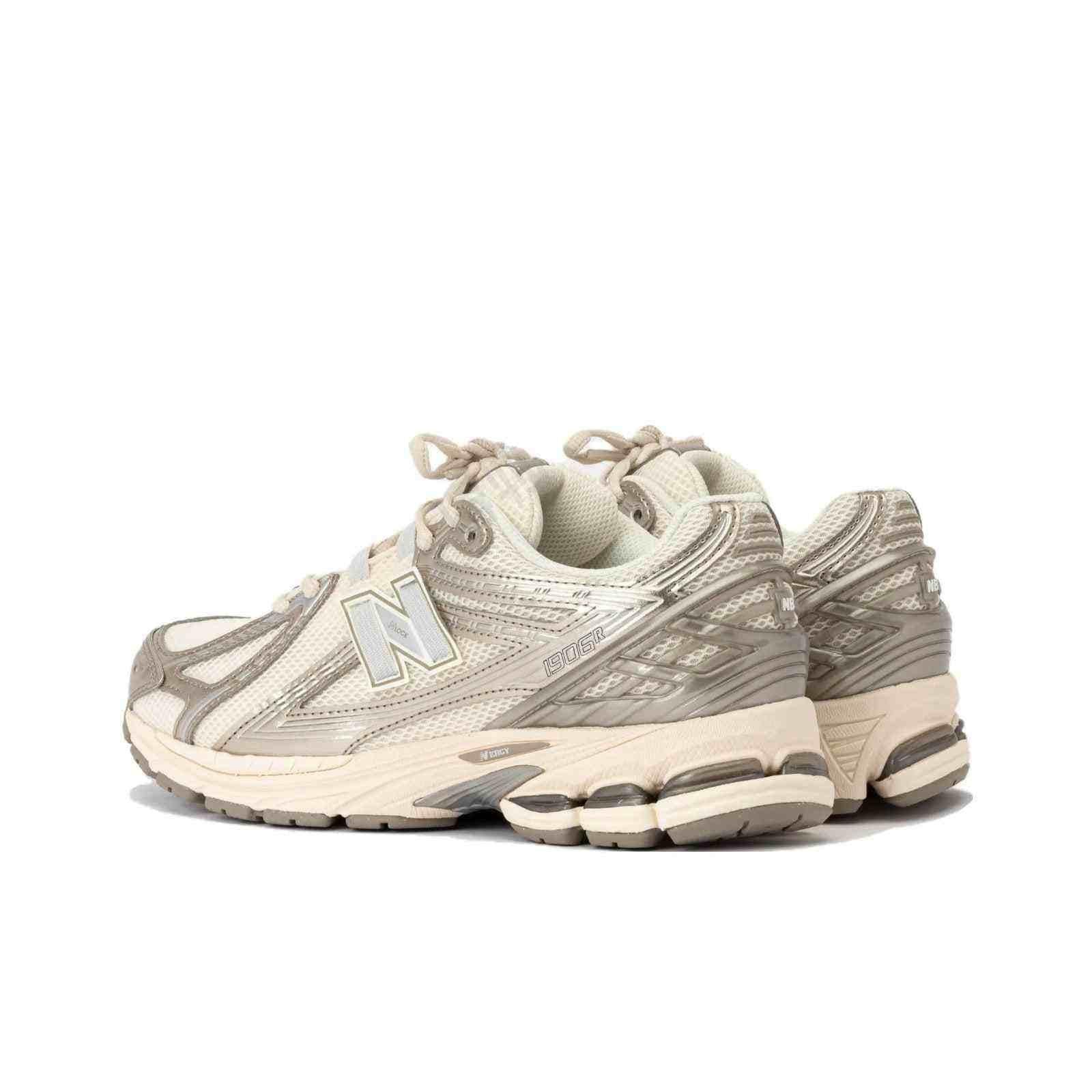 Rear three-quarter view of cream and metallic silver New Balance running shoes