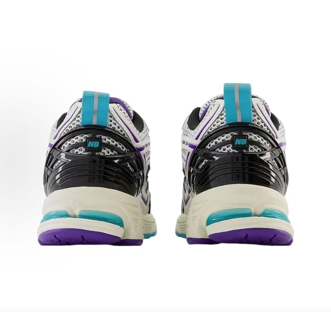 Rear view of a pair of white, teal, and purple New Balance shoes 1906R.