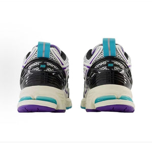 Rear view of a pair of white, teal, and purple New Balance shoes 1906R.