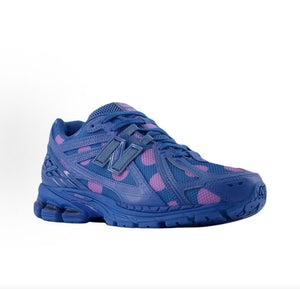 Three-quarter view of blue and purple polka dot New Balance shoes 1906R.