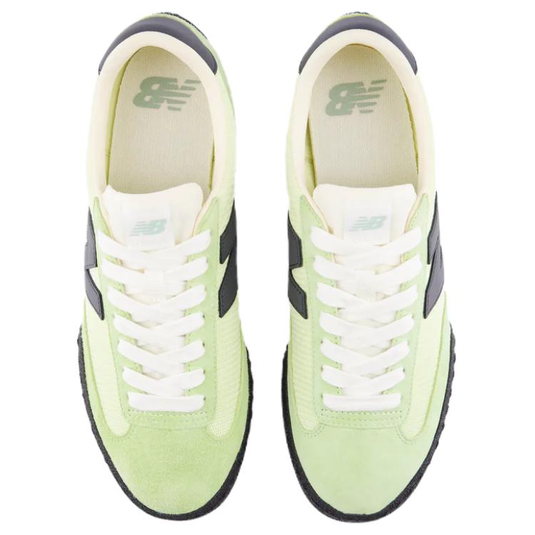 Top-down aerial view of a pair of light green and black New Balance RC30 shoes, displaying lime green suede toe caps and eyestays, pale green nylon vamps, white laces, off-white nylon tongues with light green NB logo tags, and cream-colored insoles with green printed branding.