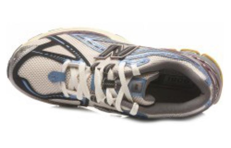 Top-down angled view of white, blue, and purple New Balance shoes 1906R model, displaying breathable white mesh uppers, metallic blue synthetic overlays, white laces, blue tongue accents, and grey collar lining.