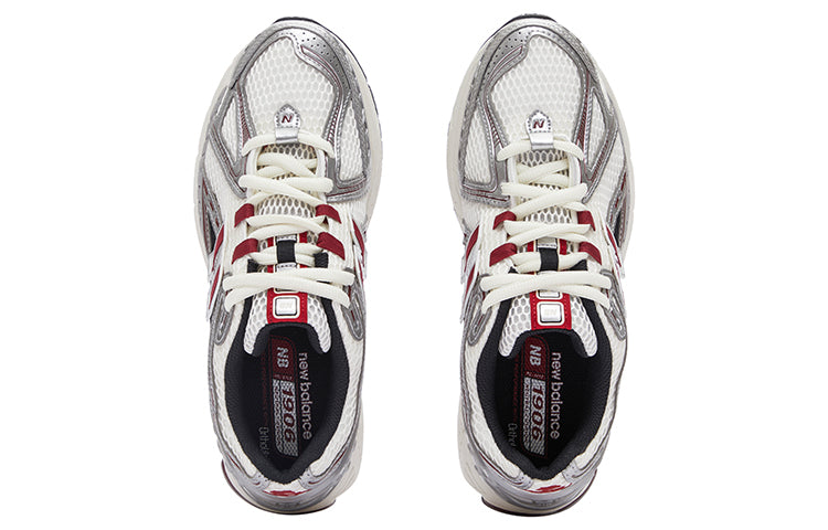 Top-down overhead view of a pair of white, silver, and red New Balance shoes 1906R sneakers.