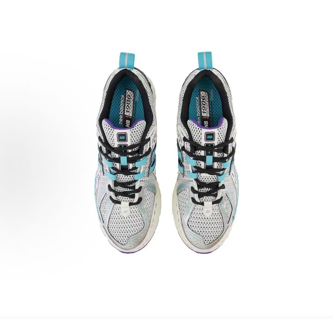 Top-down overhead view of a pair of white, teal, and purple New Balance shoes 1906R.