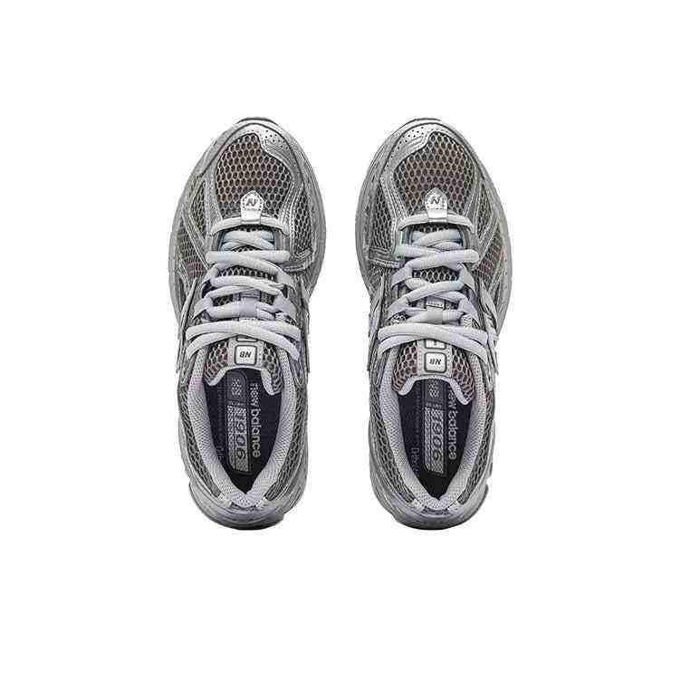 Top-down overhead view of dark grey and metallic silver New Balance running shoes