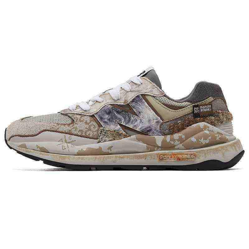 ateral side profile of custom multi-textured New Balance shoes featuring marble-patterned "N" logos, distressed suede panels, camo-printed midsole accents, and PandaPrank branding tags.