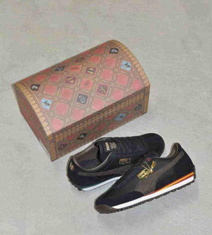Puma Easy Rider Harry Potter shoes placed next to closed Hogwarts chest special edition box.