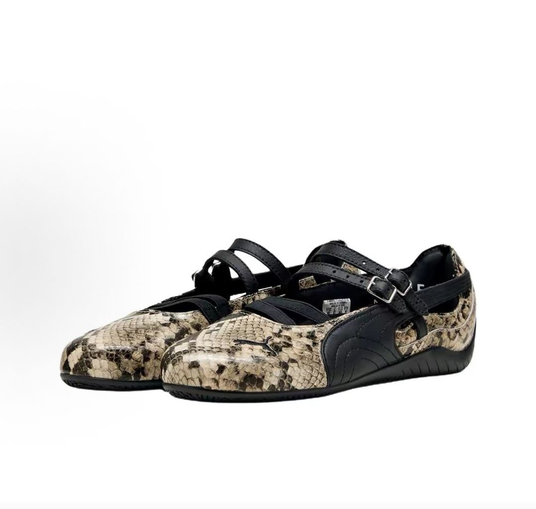 Pair of original Puma Speedcat Ballet Strap snakeskin shoes front angle view on white background.