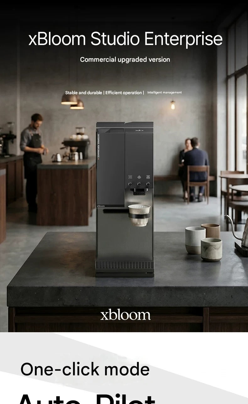 Full view of xBloom Studio Enterprise fully automatic pour-over coffee machine in a professional coffee shop setup with baristas in the background.